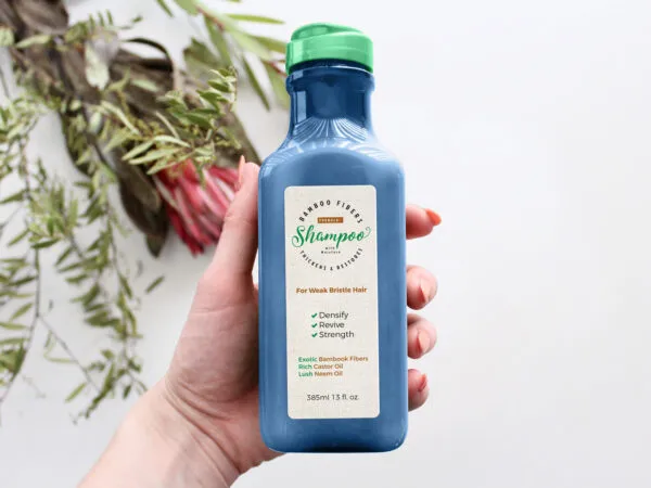 Mockup Featuring a Hand Holding an Organic Shampoo Bottle 1