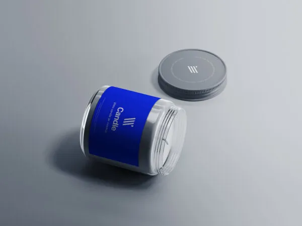 Mockup Featuring a Lying Glass Candle Jar and Its Cap on a Flat Surface 1