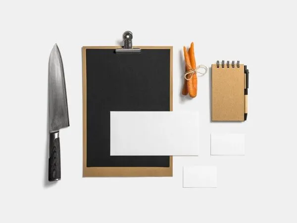 Mockup Showcasing Menu Business Cards Notebook Beside Knife and Carrots 1