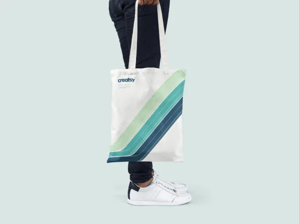 Mockup Showcasing Two Hand Holding Tote Bag Scenes 1