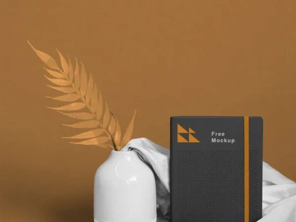 Mockup Showing Notebook Scene Decorated with Vase and Fabric 1