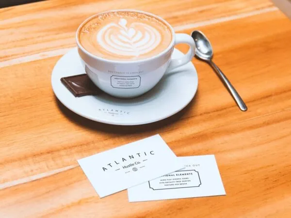 Mockup Showing Two Business Cards and Coffee Cup on Saucer 1