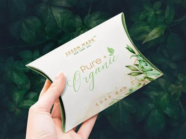 Mockup Showing a Hand Holding a Pillow Box Packaging 1
