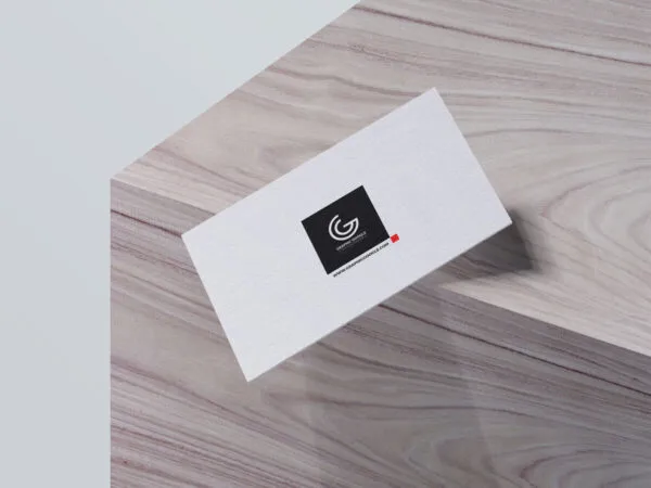Mockup of Business Card Falling off a Wooden Box in Perspective 1