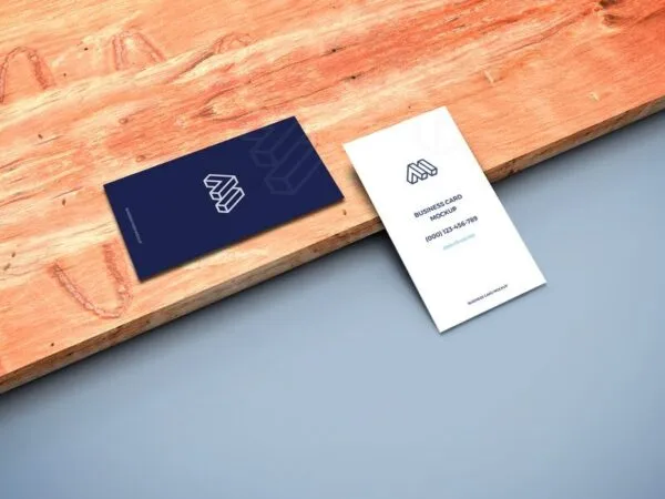 Mockup of Two Business Cards in Perspective Featuring a Wooden Board 1