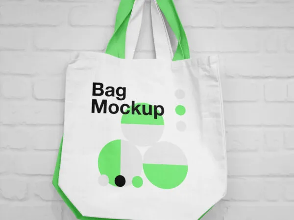Mockup of Two Canvas Bags Hanging on a Nail 1