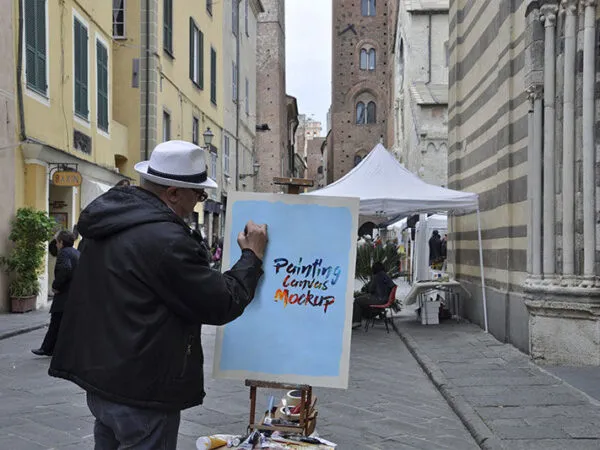 Mockup of a Man Painting on a Canvas in Street 1