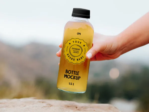 Mockup of a Transparent Bottle Held by Hand 1