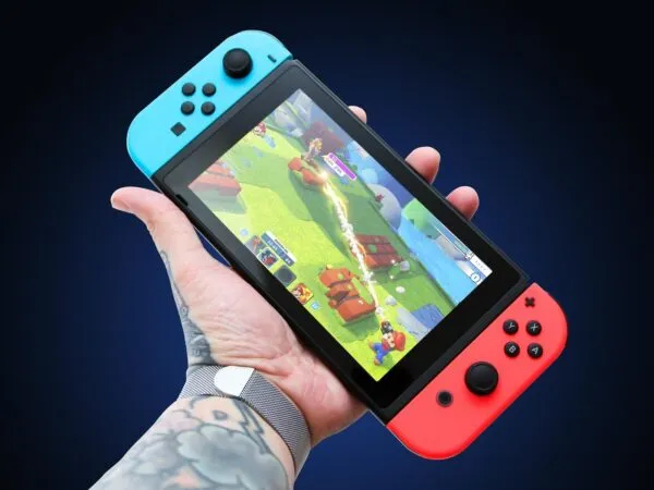 Nintendo Switch Holding by Hand Mockup 1