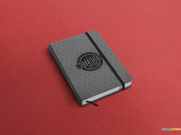 Notebook Mockup Laid on the Surface in Perspective 1