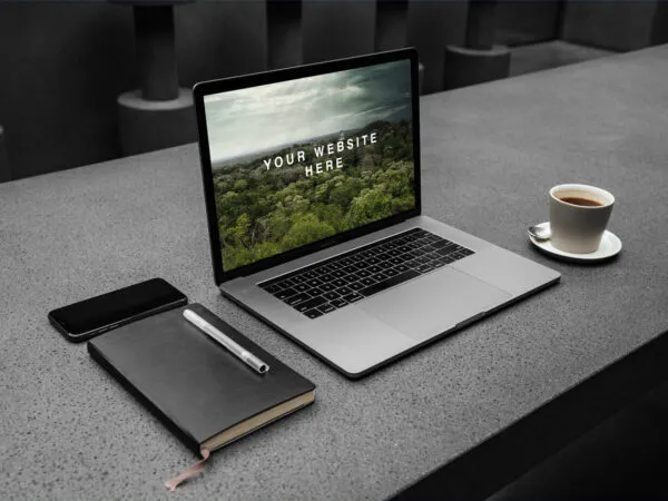 Opened MacBook on a Workspace Mockup 1