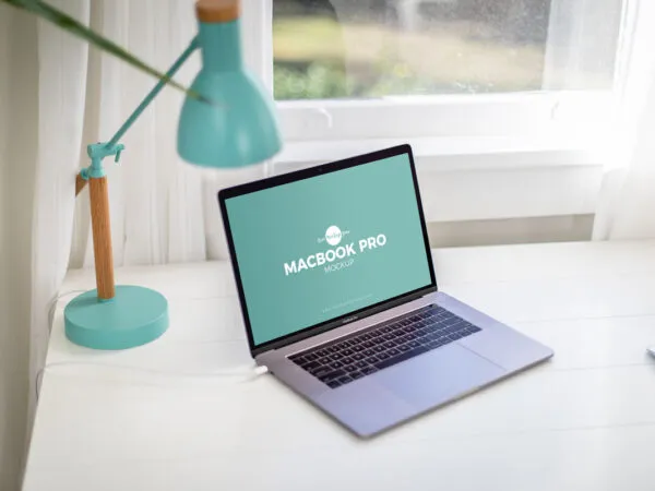 Opened Silver MacBook Pro on a Home Office Desk Mockup 1