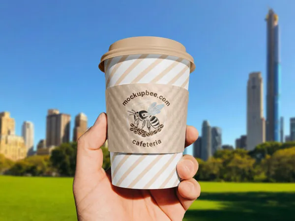 Paper Cup Sleeve in Hand Mockup 1