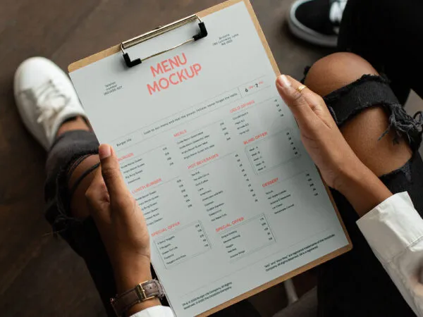 Perspective Showcase of Menu Mockup on Clipboard in Hands 1
