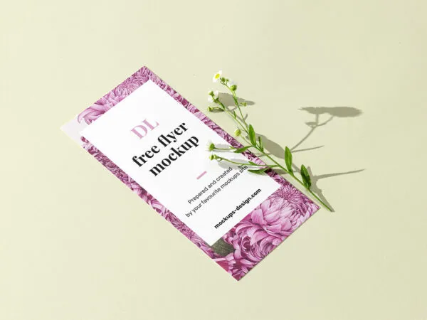 Perspective View DL Size Flyer With Flower on Clean Surface Mockup 1
