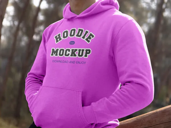 Perspective View of Man Wearing Hoodie Mockup Between Woods 1
