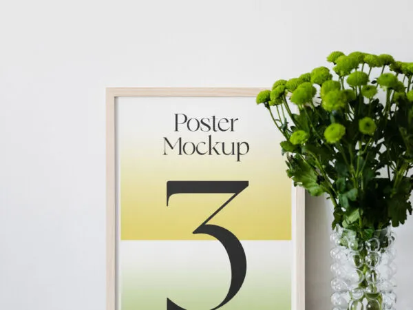 Poster Mockup on Wooden Desk and a Flower on the Right Side 1