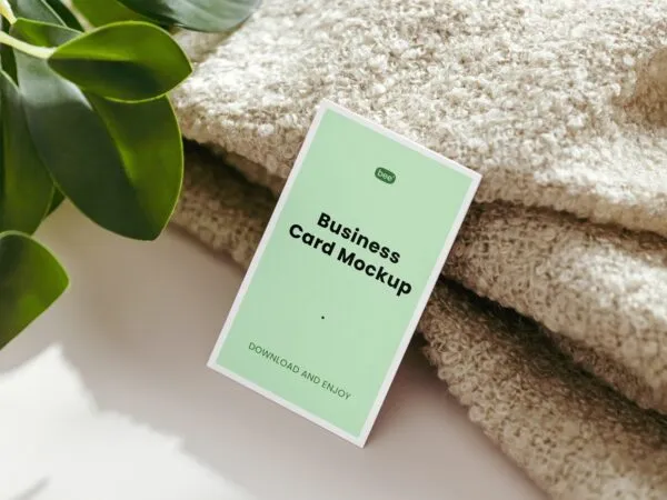 Realistic Business Card Mockup Featuring Blanket and Plant 1