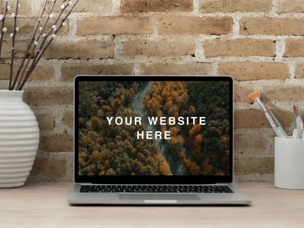 Realistic MacBook Workspace Mockup Against the Brick Wall 1