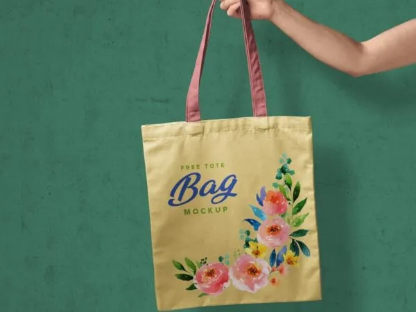 Realistic Mockup of Hand Holding a Tote Bag 1