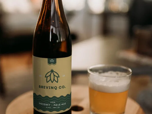 Realistic Mockup of a Beer Bottle on a Round Wooden Table 1