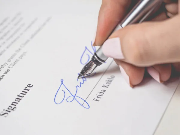 Signature Mockup of a Female Hand Holding a Fountain Pen 1