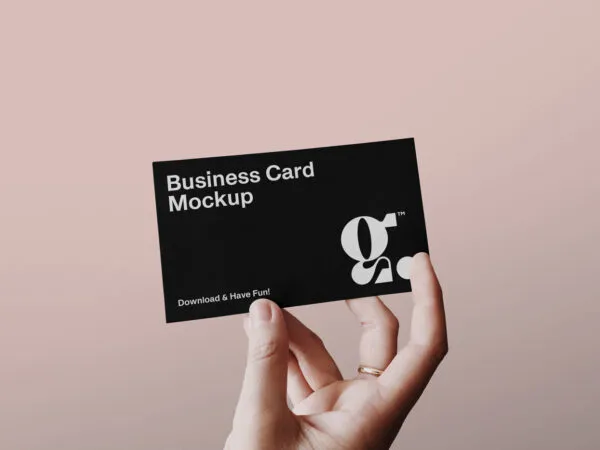 Single Business Card in a Persons Hand Mockup 1