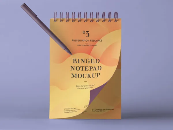 Slightly Flipped Ringed Notepad Next to a Pen Mockup 1