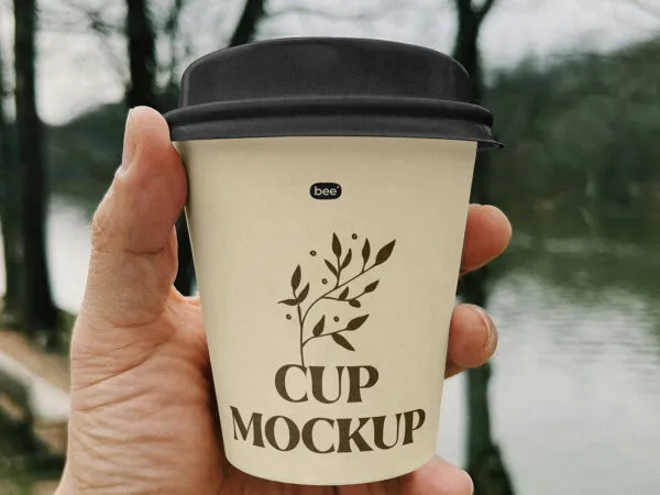 Small Paper Cup in Hand Mockup 1