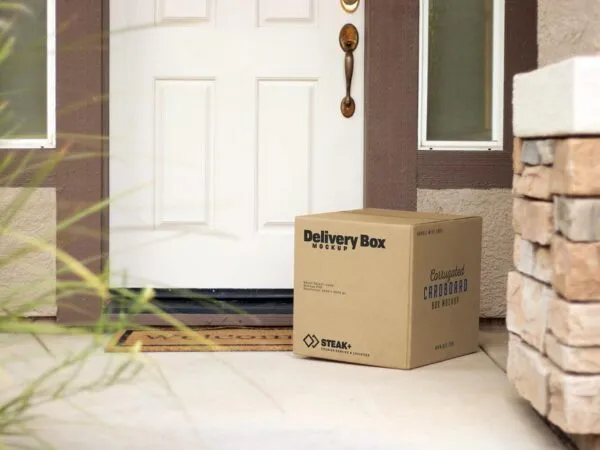 Square Delivery Box In front of a House Door Mockup 1