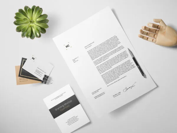 Stationery Mockup Laid in Top View Featuring an Artificial Wooden Hand 1
