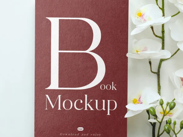 Textured Book Cover with Flower Mockup in Top View 1