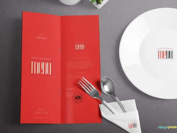 Top View Bi Fold Menu Mockup Opened Along with Plate and Napkin 1