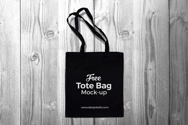 Top View Black Cotton Tote Shopping Bag on Wooden Floor Mockup 1