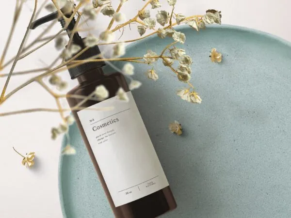 Top View Cosmetics Bottle Mockup on Tray with Flowering Plant 1