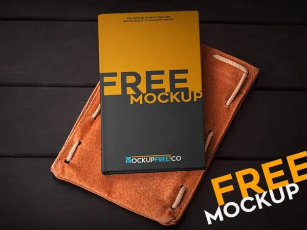 Top View Hardcover Notebook Laid Down on Leather Mockup 1