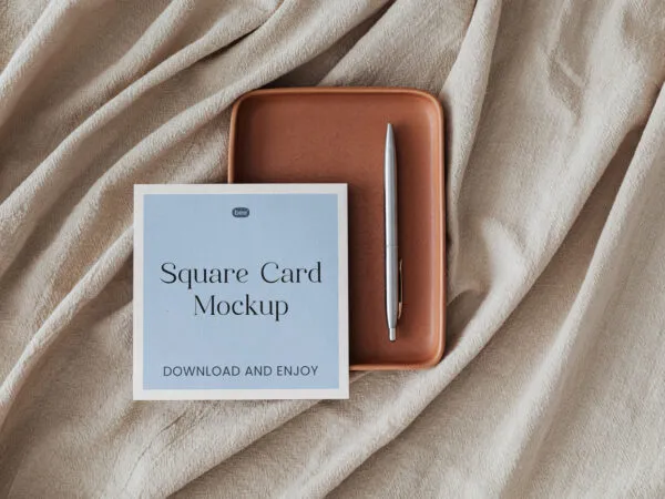 Top View of Square Card Mockup with Pen on Fabric 1