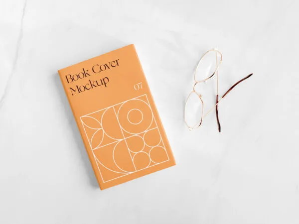 Top View of a Book Cover on Marble Surface Mockup 1