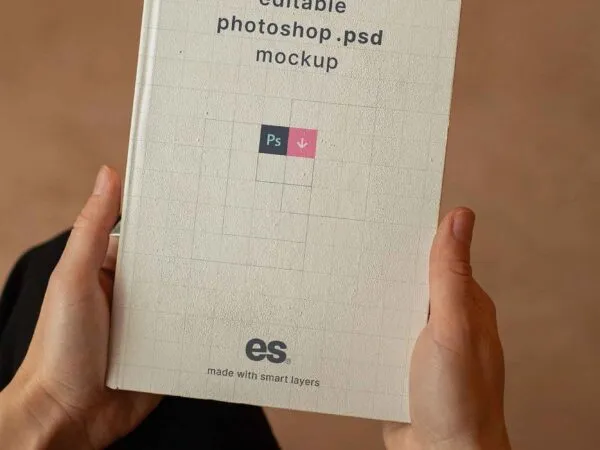 Top View of a Hand Holding Hardcover Book Mockup 1