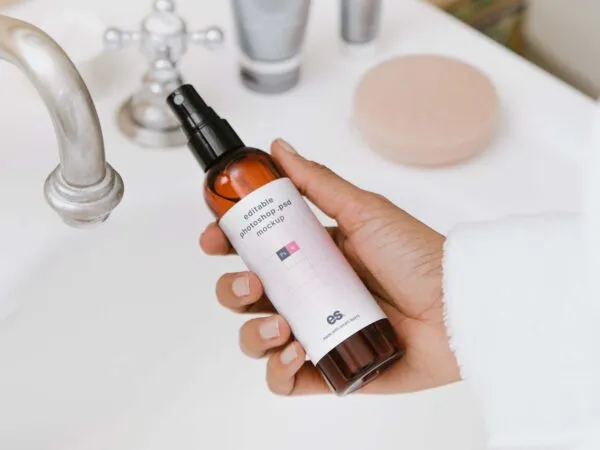 Top View of a Hand Holding Pump Spray Bottle Mockup 1