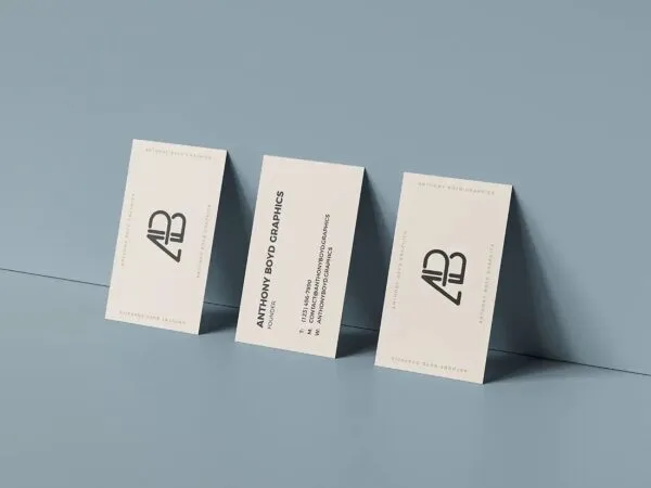 Triple Business Cards Leaned on Wall Back and Front View Mockup 1