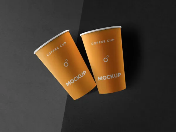 Two Coffee Cups Lying on a Flat Surface Mockup 1