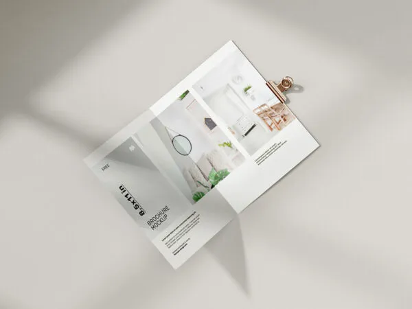 Two Folded Brochure with a Bronze Metallic Clip on the Side Mockup 1