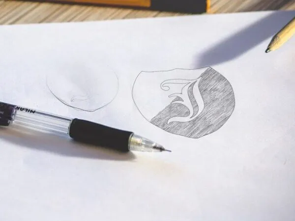 Two Logo Sketch on White Paper Mockups 1