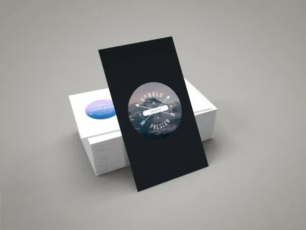 Vertical Business Card Leaning against Stack of Horizontal Cards Mockup 1