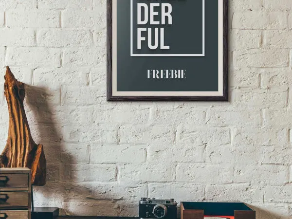 Wallderful Frame Mockups Hanging Above a Wooden Desk 1