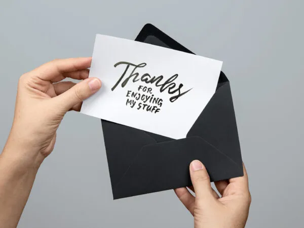Woman Holding a Greeting Card Mockup 1