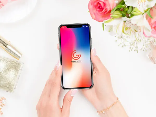 Woman Holding iPhone X Over a Dressing Table Mockup 1