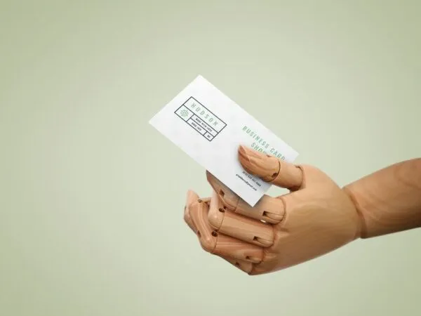 Wooden Hand Handing Out a Business Card Mockup 1
