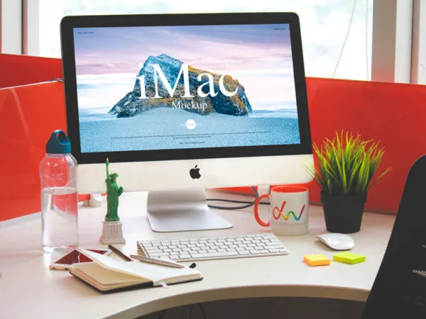 iMac on a Crowded Office Work Desk Mockup 1